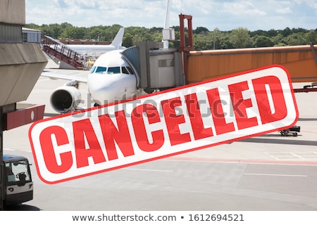 Stock fotó: Cancelled Word On Glass With Airplanes Waiting At Airport