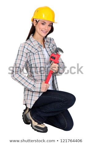 Stock photo: Female Builder Brandishing Adjustable Wrench