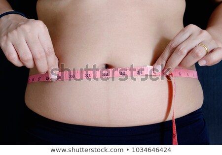 Foto d'archivio: Chubby Woman Measuring Waist Circumfence