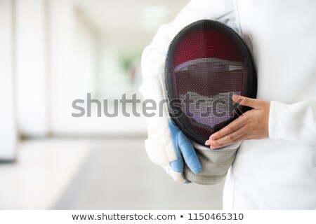 Foto stock: The Portrait Of Woman Wearing White Fencing Costume On Black