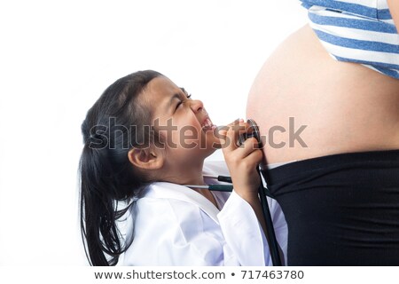 Stok fotoğraf: Girl Listening At Pregnant Mothers Belly