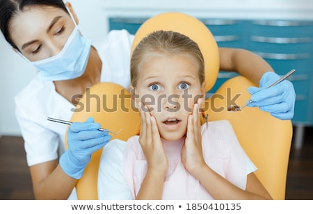 Stok fotoğraf: Frightened Woman Sitting In A Dental Chair