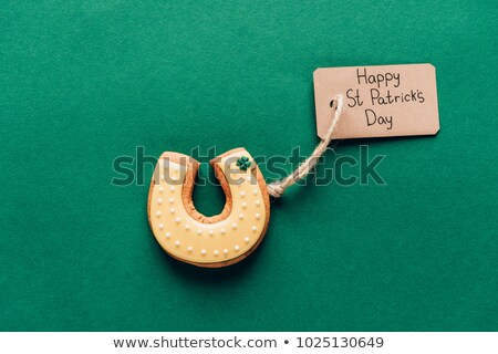 Foto d'archivio: Top View Of Icing Cookie In Shape Of Horseshoe On Green St Patricks Day Concept