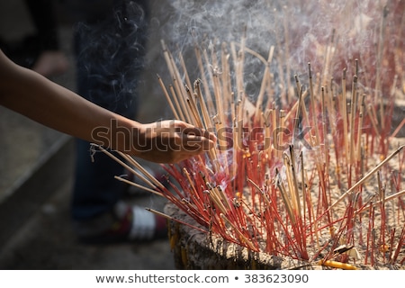 [[stock_photo]]: Incense Sticks On Joss Stick Pot Are Burning And Smoke Use For Pay Respect To The Buddha Respect To