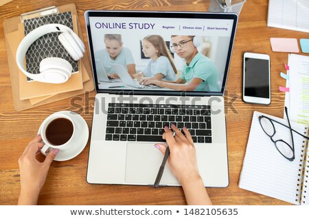 Foto stock: Human Hand Over Laptop Keypad Surfing On Website Of Distant Learning