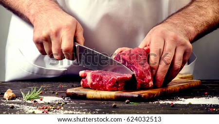 Stockfoto: Butcher Cutting Fresh Meat