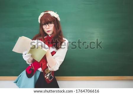 Zdjęcia stock: Student With Glasses And Long Red Hair In The Classroom