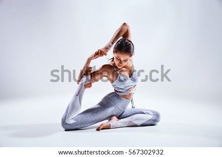 Foto d'archivio: Young Beautiful Woman Yoga Posing Isolated