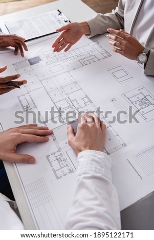 Stockfoto: Crop Hands Pointing At Blueprint