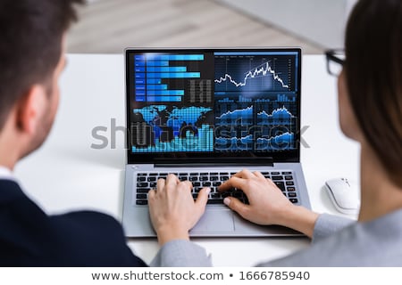 Stockfoto: Two Businesspeople Analyzing Financial Graph