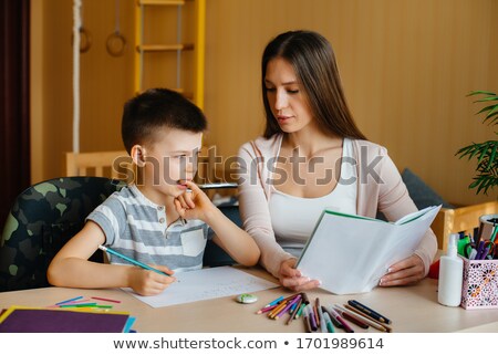 Zdjęcia stock: Portrait Of Adult Woman Watching As Her Son Doing Homework