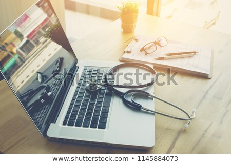 Foto d'archivio: Medical Stethoscope On Laptop In The Office