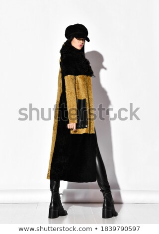 Stockfoto: Smiling Young Brunette In A Fur Coat