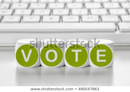 Foto stock: Letter Dice In Front Of A Keyboard - Vote