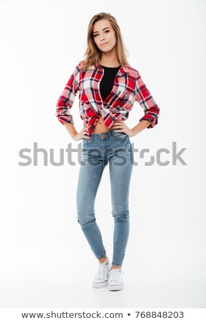 Stock fotó: Cheerful Woman In Casual Clothes Posing With Arm On Hip