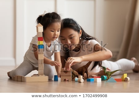 Foto stock: Mother And Child Daughter Building From Toy Blocks At Home