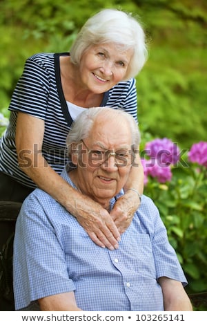 Foto stock: Portrait Of A Beautiful Elderly Couple Standing Embracing Outdoors