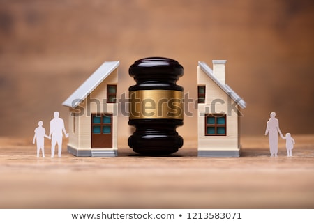 Stok fotoğraf: Gavel Between Split Family Figures And House Model