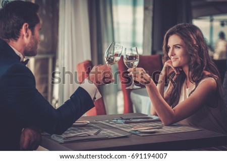 Foto stock: Happy Smiling Couple In Restaurant Celebrate