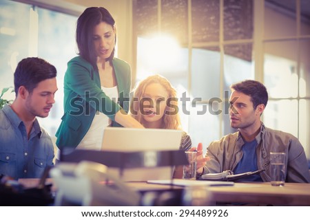 Foto stock: Group Of Young Colleagues Using Laptop