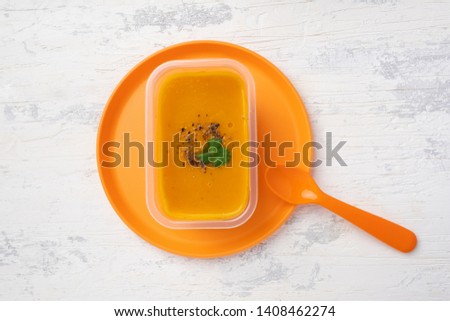 Foto stock: Pumpkin Soup In White Plate With Celery Leaves