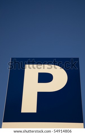 Stock photo: Close Up Of A Parking Sign Against Blue Sky