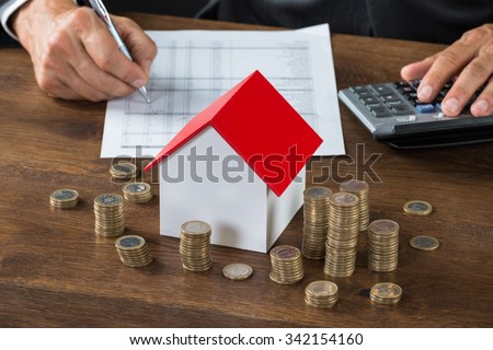 Stock photo: Property Tax And Mortgage Concept - House Model On Calculator