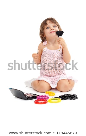 Stock photo: Charming Little Girl With Makeup And Colored Beads In The Studio