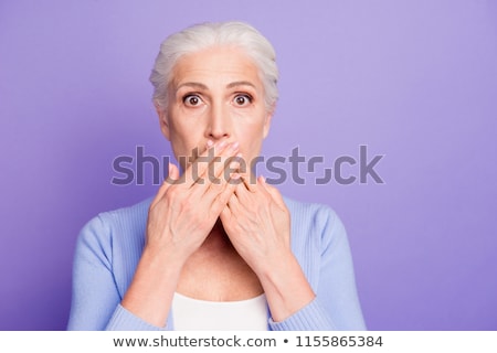 Stock fotó: Mature Woman With Hand Over Her Mouth And Shock