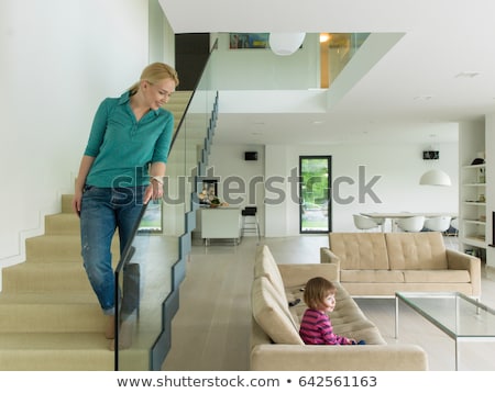 ストックフォト: Beautiful Young Lady Sitting On A Steps In Luxury House Interior