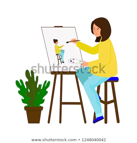 Foto stock: Young Woman Artist At Easel Painting Self Portrait
