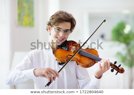 Stock photo: Young Musician Man Practicing Playing Violin At Home