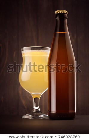 Foto stock: Beer Glass With Muddy Weizen On Dark Wood Board Vertical