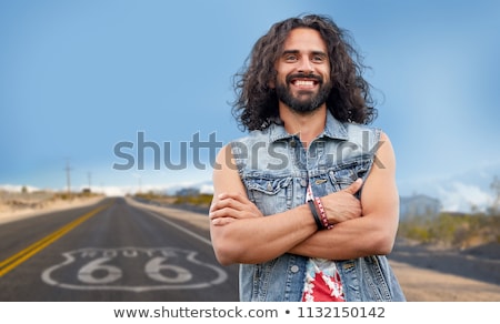 Stock photo: Smiling Hippie Man In Denim Vest Over Us Route 66