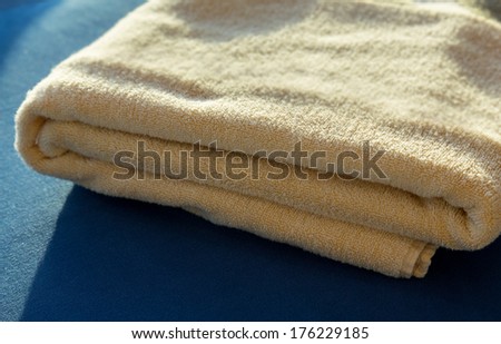 Сток-фото: Sun Shining On Stack Of Yellow Bath Towels