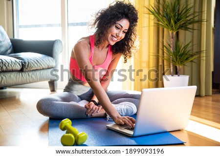 Stock photo: Woman Using Dumbbells