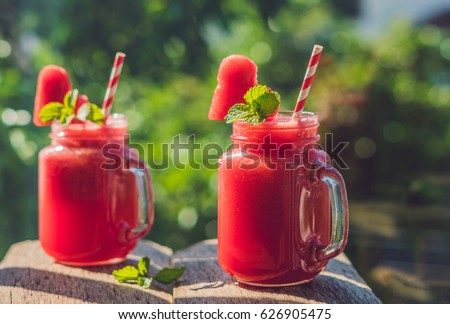 Stock fotó: Healthy Watermelon Smoothie With Mint A Piece Of Watermelon Hearts And A Striped Straw On A Wood B