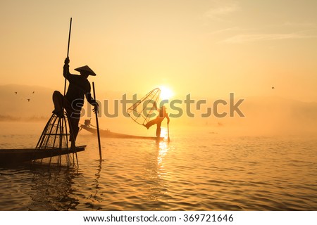 Сток-фото: Burmese Fisherman Catching Fish In Traditional Way Inle Lake Myanmar