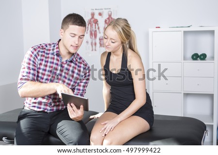 Foto stock: Male Physio Therapist And Woman Helping Patient