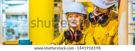 Foto d'archivio: Banner Long Format Young Man And A Little Boy Are Both In A Yellow Work Uniform Glasses And Helme