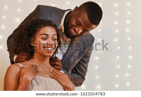Stock photo: Man Giving Gift To Woman In Restaurant