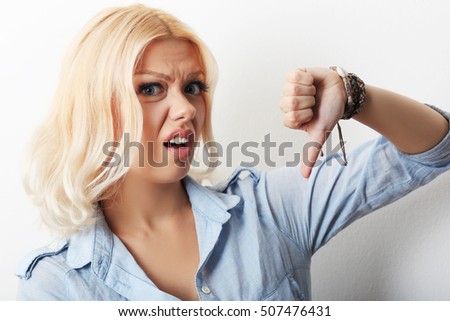 Foto stock: Sad Girl Shows Gesture With Thumbs Down