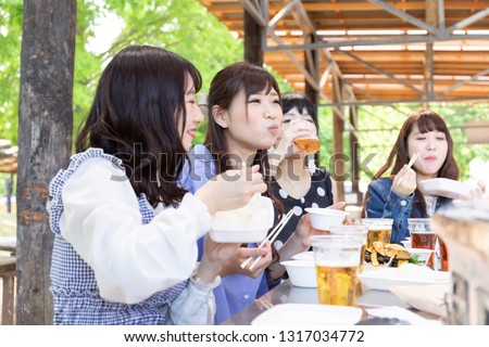 Foto stock: Young People Enjoying Barbecue Party In The Nature