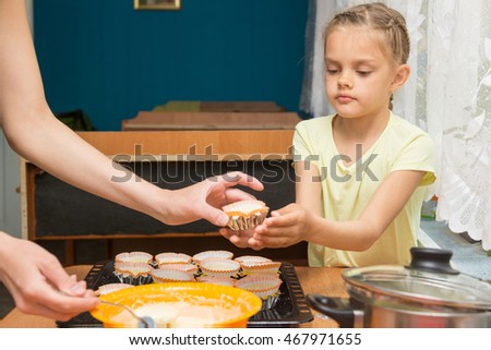 Stock photo: Daughter Helps Mum To Prepare Cupcakes For Easter