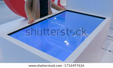 Stok fotoğraf: Hands Touching Interactive Table
