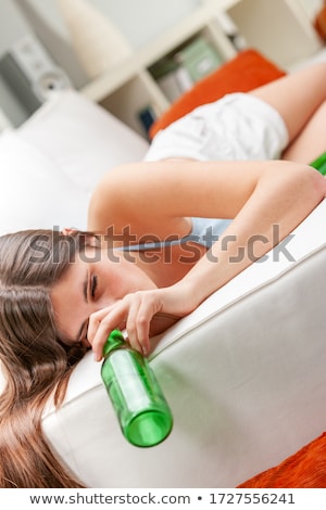 Stockfoto: Young Woman Staring Into An Empty Beer Bottle