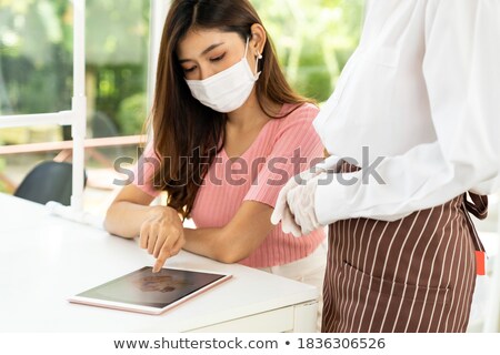 Stockfoto: New Normal Waitress Show Menu With Tablet