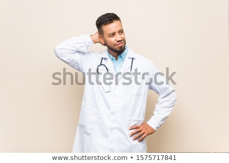 Stock fotó: Man With Coat Smiling Awkwardly