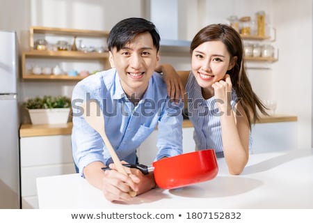 Сток-фото: Man Looking At Pot For Cooking With Expression