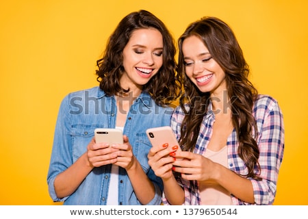 [[stock_photo]]: Two Excited Young Woman Reading An Sms